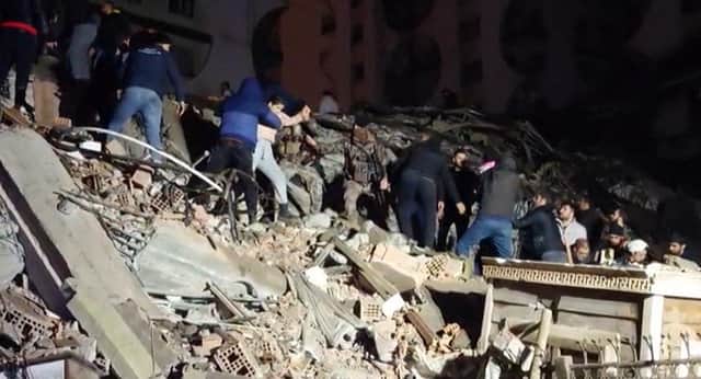 Rescuers search for victims of a 7.8-magnitude earthquake that hit Diyarbakir, in southeastern Turkey, levelling buildings across several cities and causing damages in neighbouring Syria. (Photo by Mahmut BOZARSLAN / AFPTV / AFP) (Photo by MAHMUT BOZARSLAN/AFPTV/AFP via Getty Images)