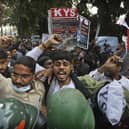 Security officers push back people shouting slogans during a protest held in support to farmers who have been on a months-long protest, in New Delhi, India. The Sikh Council UK has asked Foreign Secretary Dominic Raab to intervene.