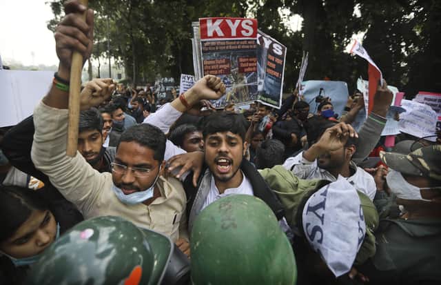 Security officers push back people shouting slogans during a protest held in support to farmers who have been on a months-long protest, in New Delhi, India. The Sikh Council UK has asked Foreign Secretary Dominic Raab to intervene.