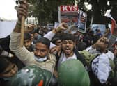Security officers push back people shouting slogans during a protest held in support to farmers who have been on a months-long protest, in New Delhi, India. The Sikh Council UK has asked Foreign Secretary Dominic Raab to intervene.