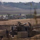 Israeli tanks and troops near the border with Gaza as ground operations, backed by airstrikes, against Hamas expanded yesterday. Picture: Dan Kitwood/Getty Images