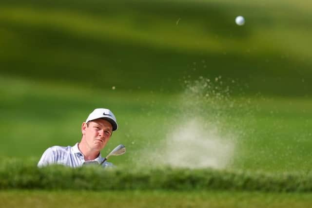 Bob MacIntyre splashes out of a bunker during the second round of the 105th PGA Championship at Oak Hill Country Club in Rochester, New York. Picture: Andrew Redington/Getty Images.