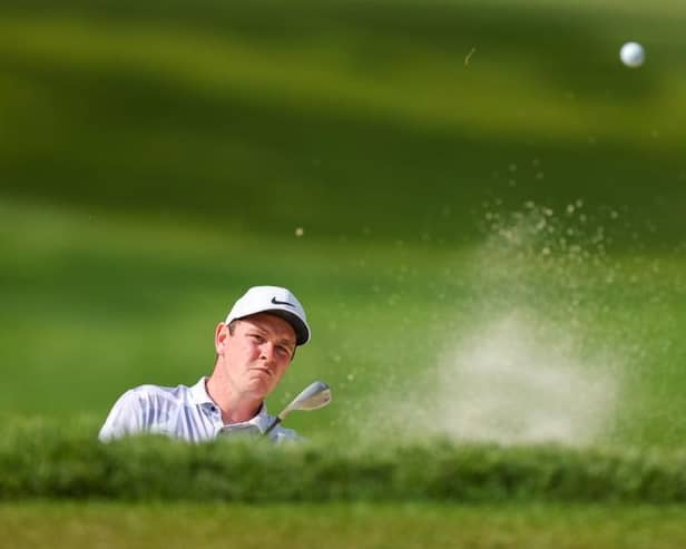 Bob MacIntyre splashes out of a bunker during the second round of the 105th PGA Championship at Oak Hill Country Club in Rochester, New York. Picture: Andrew Redington/Getty Images.