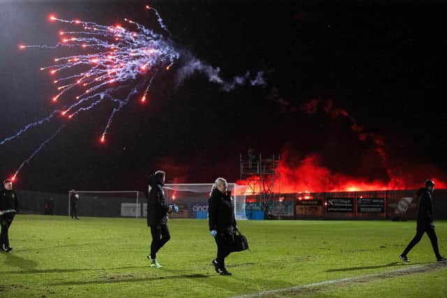 Rangers fans welcome the team pre match with pyro and fireworks.