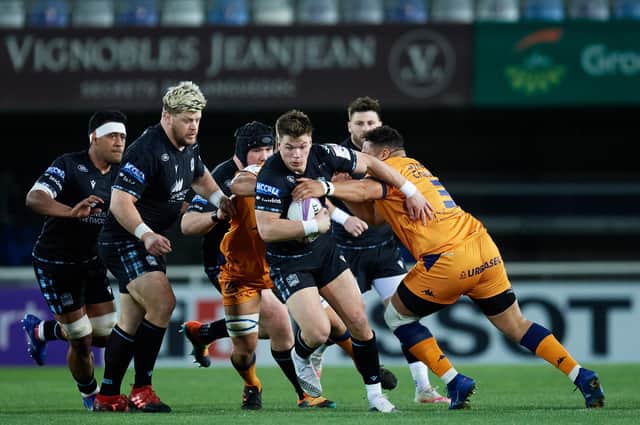 Huw Jones of Glasgow Warriors is tackled by Montpellier's Mohamed Haouas. Picture: Alex Caparros/Getty Images for EPCR