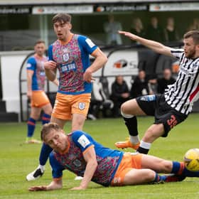 Queen's Park defender Peter Grant slides into a challenge on Dunfermline's Liam Polwarth during the Championship play-off semi-final second leg at East End Park. (Photo by Sammy Turner / SNS Group)