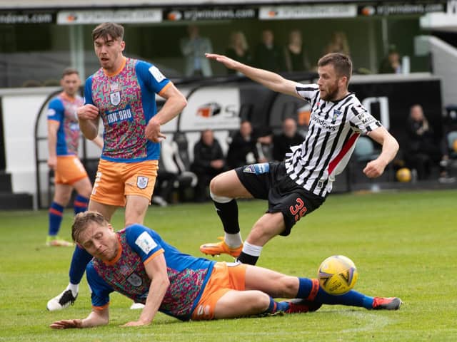 Queen's Park defender Peter Grant slides into a challenge on Dunfermline's Liam Polwarth during the Championship play-off semi-final second leg at East End Park. (Photo by Sammy Turner / SNS Group)