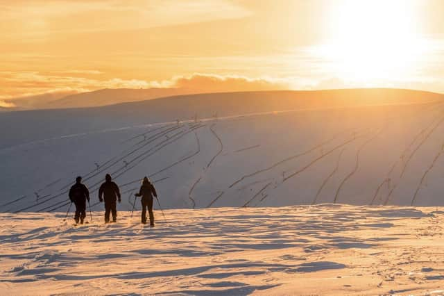 Skiers enjoy the sunset from near the top of the Buzzard tow at The Lecht PIC: Stevie McKenna / ski-scotland