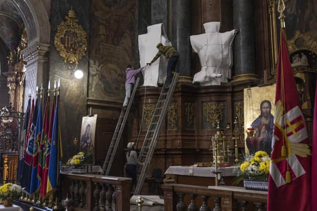 Statues are wrapped at the 'Saint' Peter and Paul Garrison Church in Lviv, Ukraine, where locals have volunteered to protect the city's cultural heritage in the face of Russian attack. (Photo by Dan Kitwood/Getty Images)