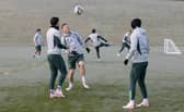Callum McGregor and Mikey Johnston prepare in freezing conditions for Celtic's match against St Johnstone.