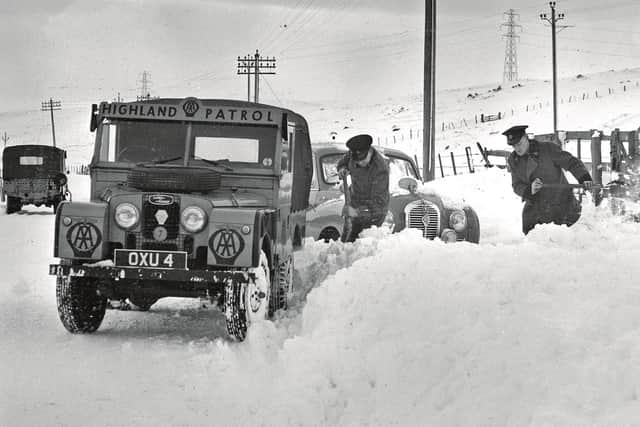 An AA Highland Patrol Land Rover being used to free a snowbound Austin A40 Somerset in the mid-1950s.