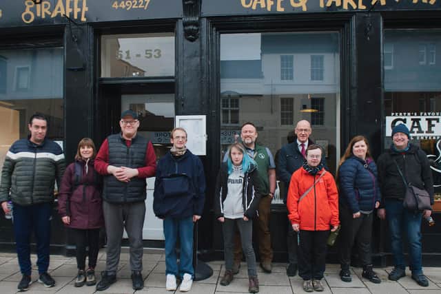 John Swinney pictured with service users outside the Giraffe café and training kitchen in Perth. Picture: Becky Duncan