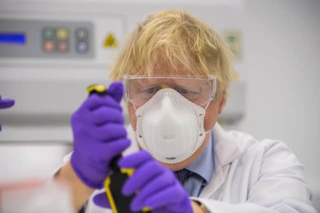 Prime Minister Boris Johnson tried his hand at one of the tests as he visits the French biotechnology laboratory Valneva in Livingston.