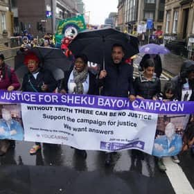 The sister of Sheku Bayoh, Kadi Johnston (centre) and Human rights lawyer Aamer Anwar (centre right) during a anti-racism and anti-fascist march in Glasgow. The inquiry into the death of a man who was restrained by police will hear from his family for the first time as hearings resume on Tuesday.