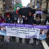 The sister of Sheku Bayoh, Kadi Johnston (centre) and Human rights lawyer Aamer Anwar (centre right) during a anti-racism and anti-fascist march in Glasgow. The inquiry into the death of a man who was restrained by police will hear from his family for the first time as hearings resume on Tuesday.