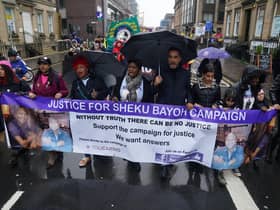 The sister of Sheku Bayoh, Kadi Johnston (centre) and Human rights lawyer Aamer Anwar (centre right) during a anti-racism and anti-fascist march in Glasgow. The inquiry into the death of a man who was restrained by police will hear from his family for the first time as hearings resume on Tuesday.