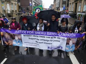The sister of Sheku Bayoh, Kadi Johnston (centre) and Human rights lawyer Aamer Anwar (centre right) during a anti-racism and anti-fascist march in Glasgow. The inquiry into the death of a man who was restrained by police will hear from his family for the first time as hearings resume on Tuesday.