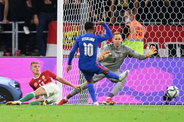 England's forward Raheem Sterling (C) scores the 0-1 during the FIFA World Cup Qatar 2022 qualification Group I football match between Hungary and England, at the Puskas Arena in Budapest on September 2, 2021. (Photo by ATTILA KISBENEDEK/AFP via Getty Images)