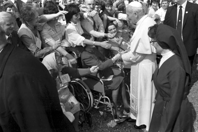 Well-wishers stretch out to touch Pope John Paul II at St Joseph's Hospital, in Rosewell.