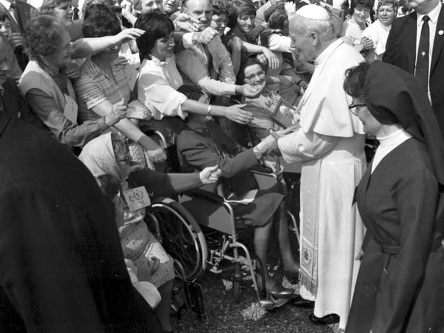 Well-wishers stretch out to touch Pope John Paul II at St Joseph's Hospital, in Rosewell.