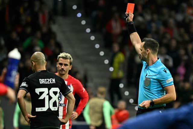 Austrian referee Konrad Plautz presents a red card to Celtic's Daizen Maeda.