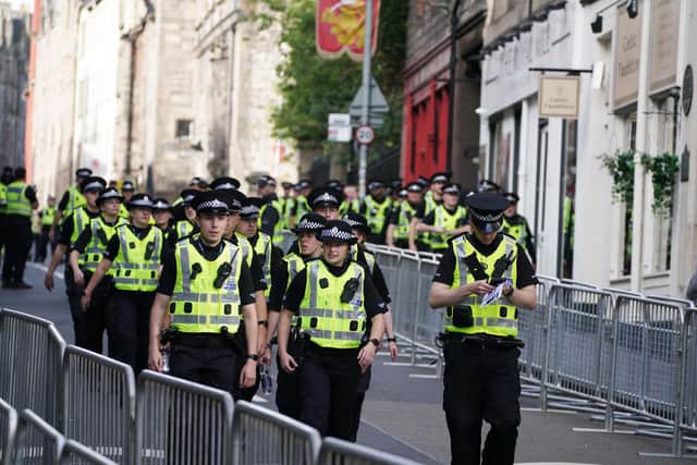 Police officers on the Royal Mile in Edinburgh before Queen Elizabeth II's coffin was transported on a six-hour journey from Balmoral to the Palace of Holyroodhouse in Edinburgh.
