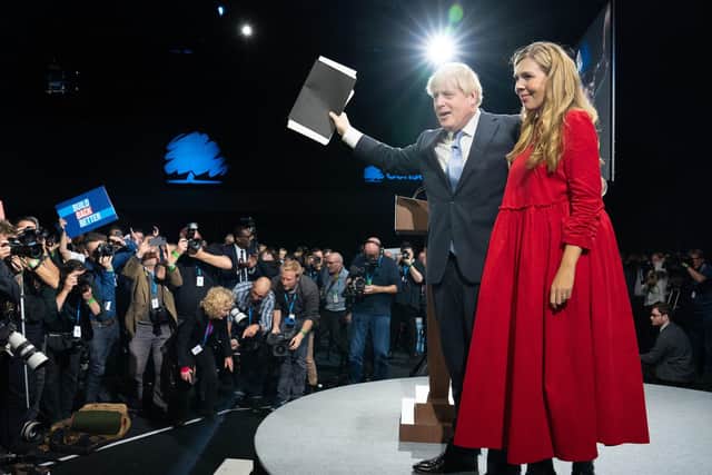 Prime Minister Boris Johnson is joined by his wife Carrie on stage after delivering his keynote speech at the Conservative Party Conference