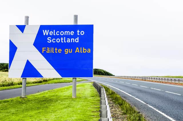 A Welcome to Scotland road sign at the Scotland/England border on the A1