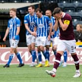 Kilmarnock players celebrate while Hearts captain Lawrence Shankland is dejected. (Photo by Mark Scates / SNS Group)
