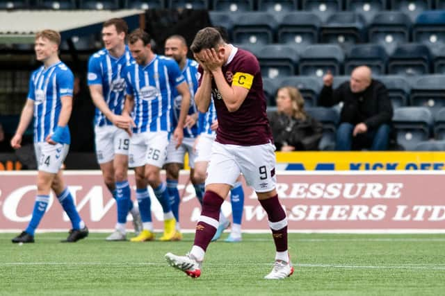 Kilmarnock players celebrate while Hearts captain Lawrence Shankland is dejected. (Photo by Mark Scates / SNS Group)