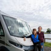 Paul Merton and Suki Webster relax against their motorhome. Picture  PA Photo/Channel 5/Curve Media