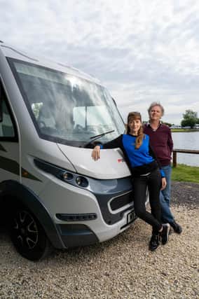 Paul Merton and Suki Webster relax against their motorhome. Picture  PA Photo/Channel 5/Curve Media