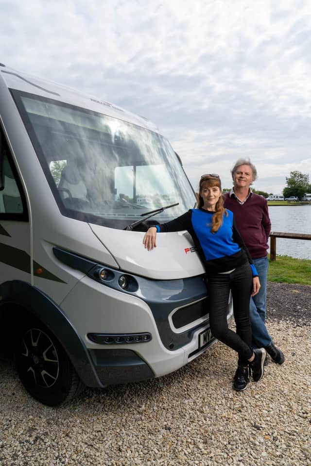 Paul Merton and Suki Webster relax against their motorhome. Picture PA Photo/Channel 5/Curve Media