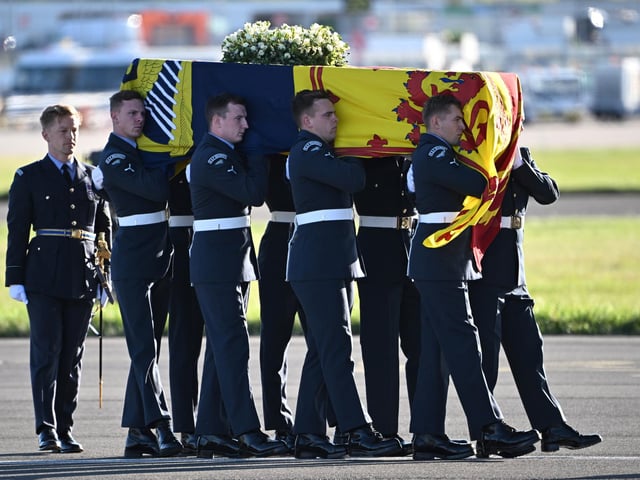 A bearer party from Queen's Colour Squadron of the Royal Air Force (RAF) carry the coffin of Queen Elizabeth II aboard an RAF aircraft on its journey from Edinburgh to Buckingham Palace, London, where it will lie at rest.