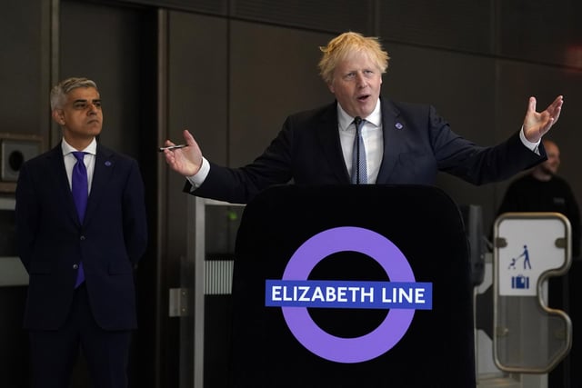 Mayor of London Sadiq Khan (left) looks on as Prime Minister Boris Johnson makes a speech at Paddington station in London, to mark the completion of London's Crossrail project.
