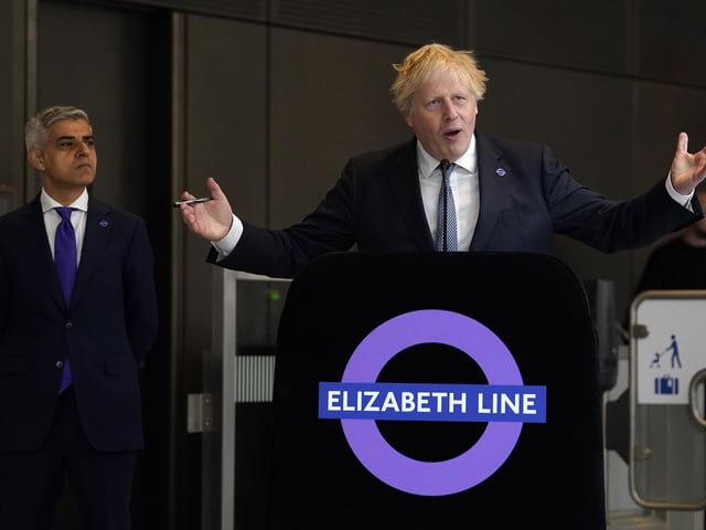 Mayor of London Sadiq Khan (left) looks on as Prime Minister Boris Johnson makes a speech at Paddington station in London, to mark the completion of London's Crossrail project.