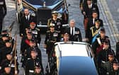 King Charles III, flanked by Princess Anne, Prince Andrew, and Prince Edward walk behind the procession of Queen Elizabeth II's coffin, from the Palace of Holyroodhouse to St Giles Cathedral, on the Royal Mile in Edinburgh (Picture: Oli Scarff/AFP via Getty Images)