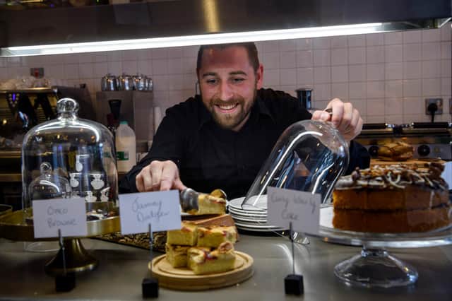 Café 1505 manager, Craig Massie, helps himself to a slice of cake