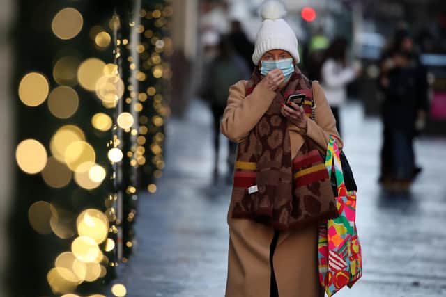 A member of the public wearing a face covering shopping on Buchanan Street in Glasgow.