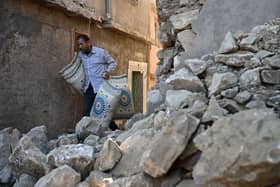 A man walks past destroyed homes in the mountain village of Moulay Brahim in the central province of al-Haouz. Picture: AFP via Getty Images