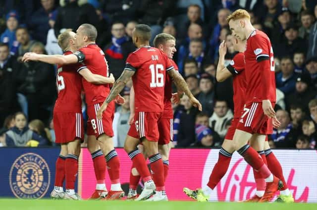 Aberdeen's Scott Brown (left) celebrates making it 2-0 during a Cinch Premiership match between Rangers and Aberdeen at Ibrox . Photo by Alan Harvey / SNS Group)