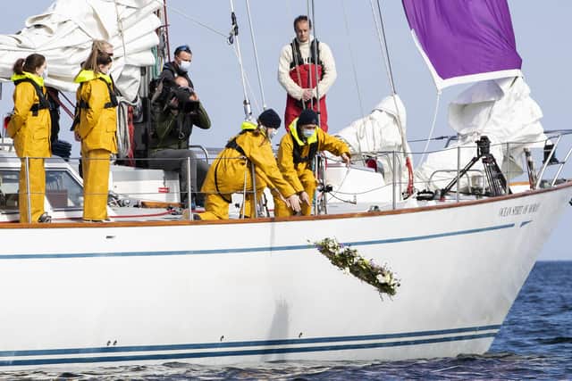 Young sailors at Gordonstoun lay a wreath off the coast of Hopeman Harbour, where Prince Philip first learned to sail.