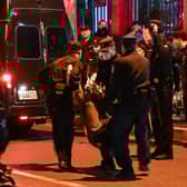 A man is arrested while people gathering on a street in Shanghai on November 27, 2022, where protests against China's zero-Covid policy took place the night before following a deadly fire in Urumqi, the capital of the Xinjiang region. (Photo by Hector RETAMAL / AFP) (Photo by HECTOR RETAMAL/AFP via Getty Images)