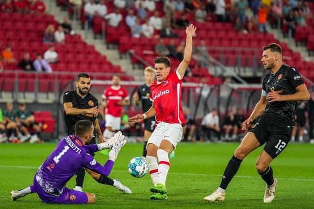 Dundee United goalkeeper Mark Birighitti tries to stop AZ Alkmaar's Milos Kerkez during a chastening night for the Scottish team.