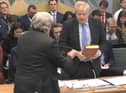 The Clerk to the Committee (left) administers the oath to former prime minister Boris Johnson ahead of his evidence to the Privileges Committee.