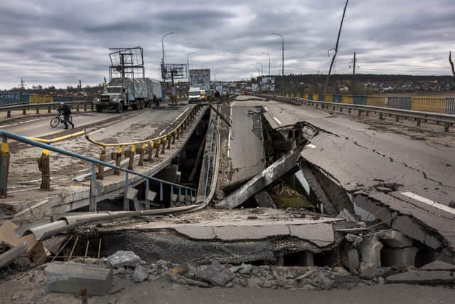 A Ukrainian Army truck stops at a war damaged bridge on April 20, 2022 in Bucha, Ukraine. Ukrainian soldiers are busy reconnecting suburbs of Kiev more than a month after Russian troops invaded the area. (Photo by John Moore/Getty Images)