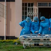 Medical staff dressed in personal protective equipment prepare to go to work in the main Covid-19 treatment centre at Kamuzu Central Hospital in Lilongwe, Malawi (Picture: Amos Gumulira/AFP via Getty Images)