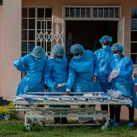 Medical staff dressed in personal protective equipment prepare to go to work in the main Covid-19 treatment centre at Kamuzu Central Hospital in Lilongwe, Malawi (Picture: Amos Gumulira/AFP via Getty Images)