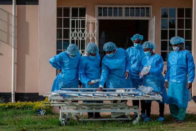 Medical staff dressed in personal protective equipment prepare to go to work in the main Covid-19 treatment centre at Kamuzu Central Hospital in Lilongwe, Malawi (Picture: Amos Gumulira/AFP via Getty Images)