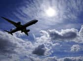 A plane flies in to land. US and EU travellers who are fully vaccinated against coronavirus will be allowed to enter England and Scotland without the need to quarantine from Monday. Picture: Steve Parsons/PA Wire